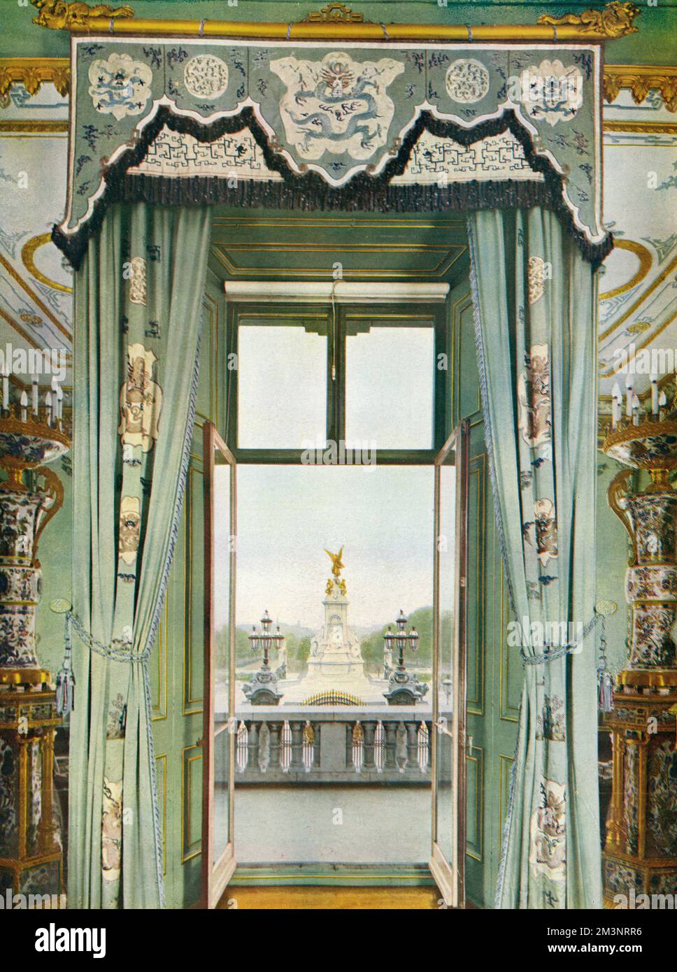 An unusual scene of the interior of the royal balcony at Buckingham Palace, from the centre room: a spot where royals have stood on many historic occasions during loyal demonstrations by crowds at the gates. Above the parapet of the balcony is the Victoria Memorial, and beyond that, the Mall.The interior of the Centre Room was redecorated by Queen Mary in an Oriental style to harmonise with the original English Chinoiserie features, which were brought up from the Banqueting Room of the Brighton Pavilion.     Date: 1935 Stock Photo
