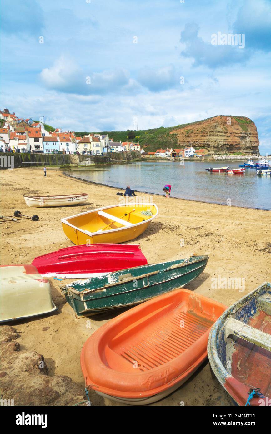 Staithes harbour, beach and cliffs from beach at high tide. North