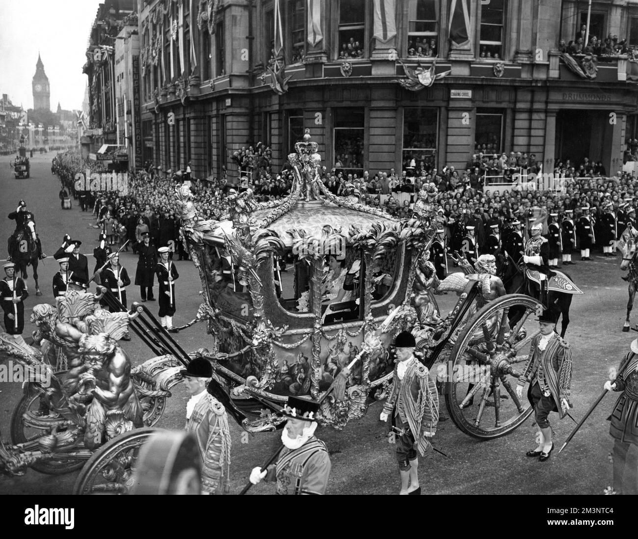 Queen Elizabeth II drives through Trafalgar Square in central London in the golden State coach on the way to Westminster Abbey for her Coronation on 2 June 1953.       Date: 1953 Stock Photo