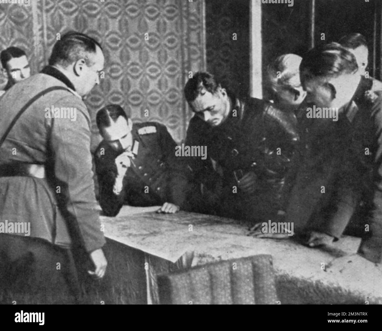 Russian Commander Borowenski bends over a map of Poland during discussions between German and Russian officers about the demarcation of the country following the invasion by Germany and Russia in September 1939.       Date: 1939 Stock Photo