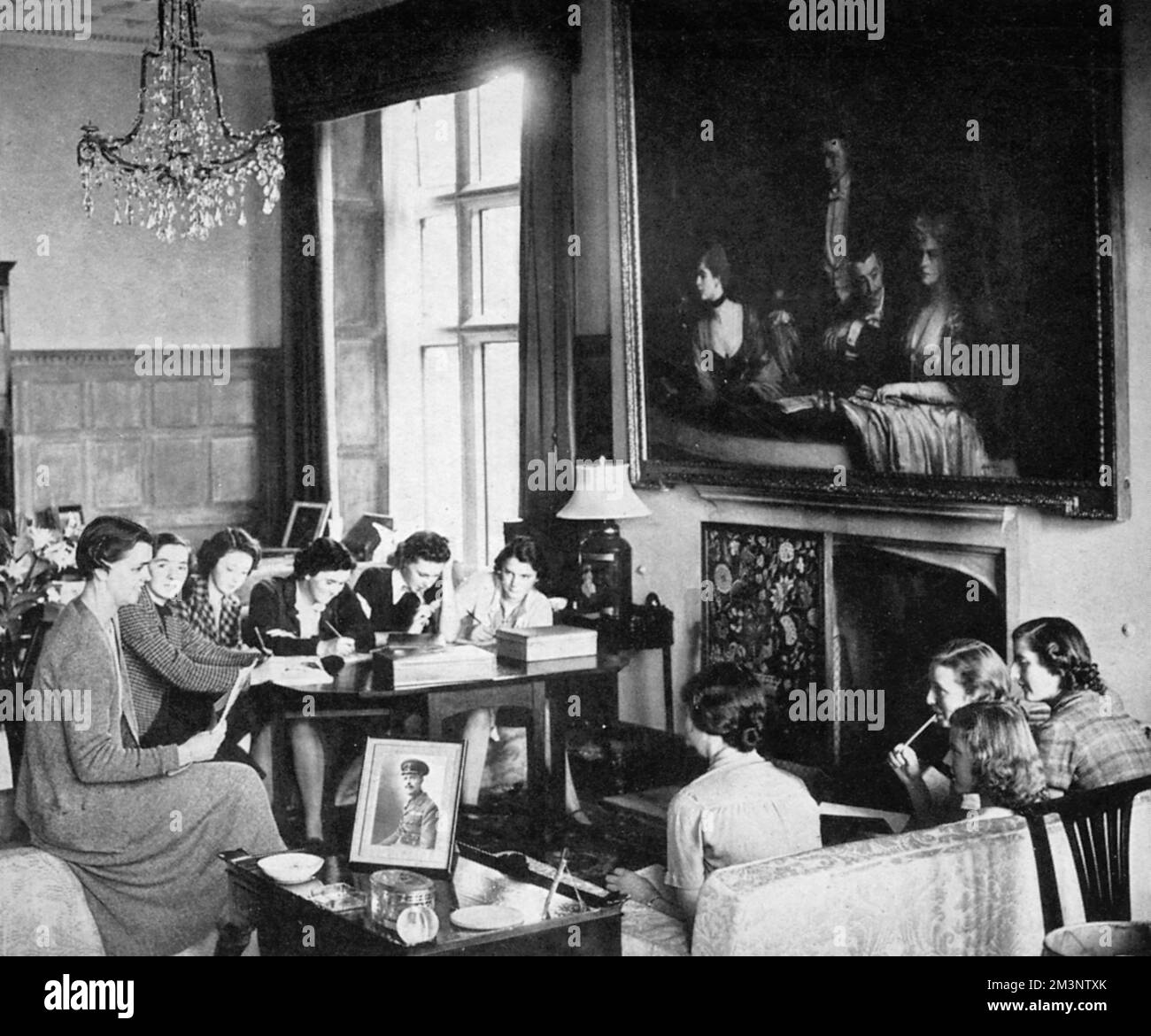 A finishing school for wartime debutantes relocated from Florence to a large country house in Hampshire.  Here, girls who would in peacetime have been sent abroad to learn a foreign language and be 'finished', also learn more practical skills such as first aid, home nursing, domestic science and cookery.       Date: 1939 Stock Photo