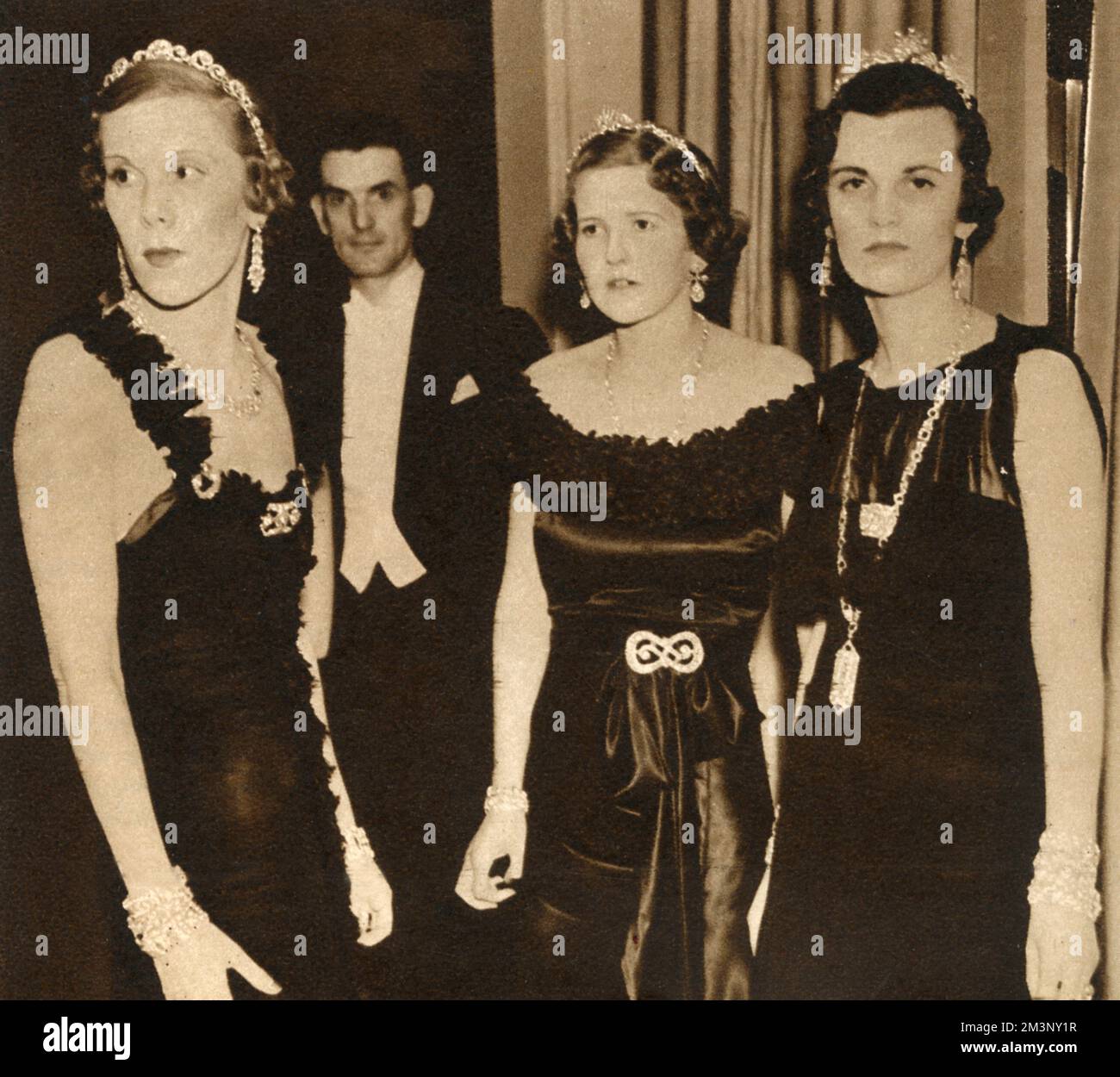 Three of the ladies at the Jewels of Empire Ball, held in June 1935 at the Grosvenor House Hotel.  Over 3 million pounds worth of jewels were worn in the shape of bracelets, tiaras, necklaces, rings and clips, all lent by the National Jewellers' Association.  Photograph shows Lady Veronica Hornby, Mrs John Musker and Mrs Charles Sweeny (formerly Miss Margaret Whigham, later the Duchess of Argyll).       Date: 1935 Stock Photo