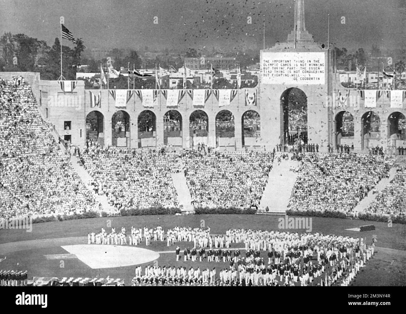The inauguration of the athletic contests at the 1932 Olympic Games in Los Angeles, with part of the huge stadium with stands filled shown, and athletes lining up in the centre.     Date: 1932 Stock Photo