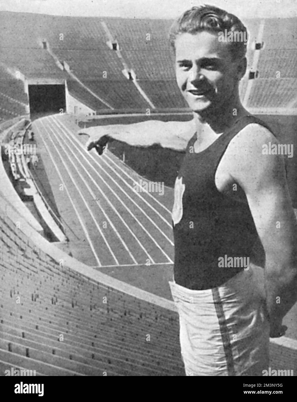 Frank Clifford Wyckoff (1909 1980) was an American athlete and triple gold medal winner in 4x100 m relay at the Olympic Games in 1924, 1928 and 1932.  Pictured here pointing to the scene of the 'Olympic pageant'.         Date: 1932 Stock Photo