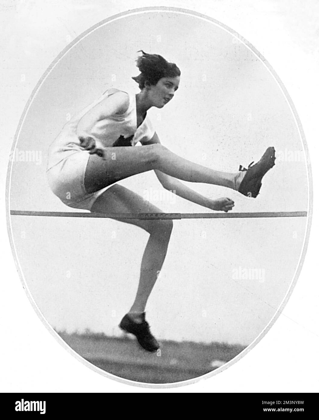 Ethel Mary Catherwood (1908-1987), Canadian athlete and winner of the first women's Olympic gold medal in the high jump at the 1928 Amsterdam Olympic Games, setting a world record in the process. Pictured in action - she was offered a film contract after the Olympics.  1928 Stock Photo