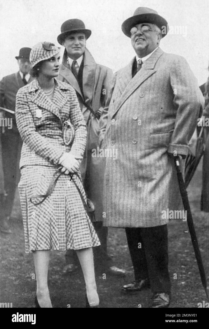 Miss Margaret Whigham (1912-1993), later Mrs Charles Sweeny and then Margaret Campbell, Duchess of Argyll, pictured in 1931 at the autumn race meeting at Newbury with H.H. The Prince Aga Khan, who had seven horses running at the meeting.  The Aga Khan's son, Prince Aly Khan, had fallen in love with Margaret in the previous year, but the romance was discouraged by her parents.         Date: 1931 Stock Photo