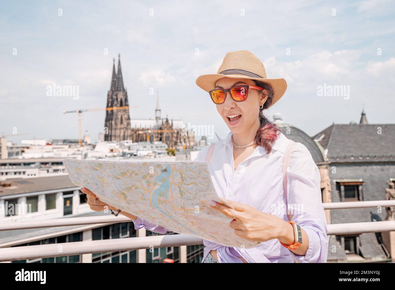 Tourist girl with maps, navigating for sights and landmarks and geolocating on the streets of an 