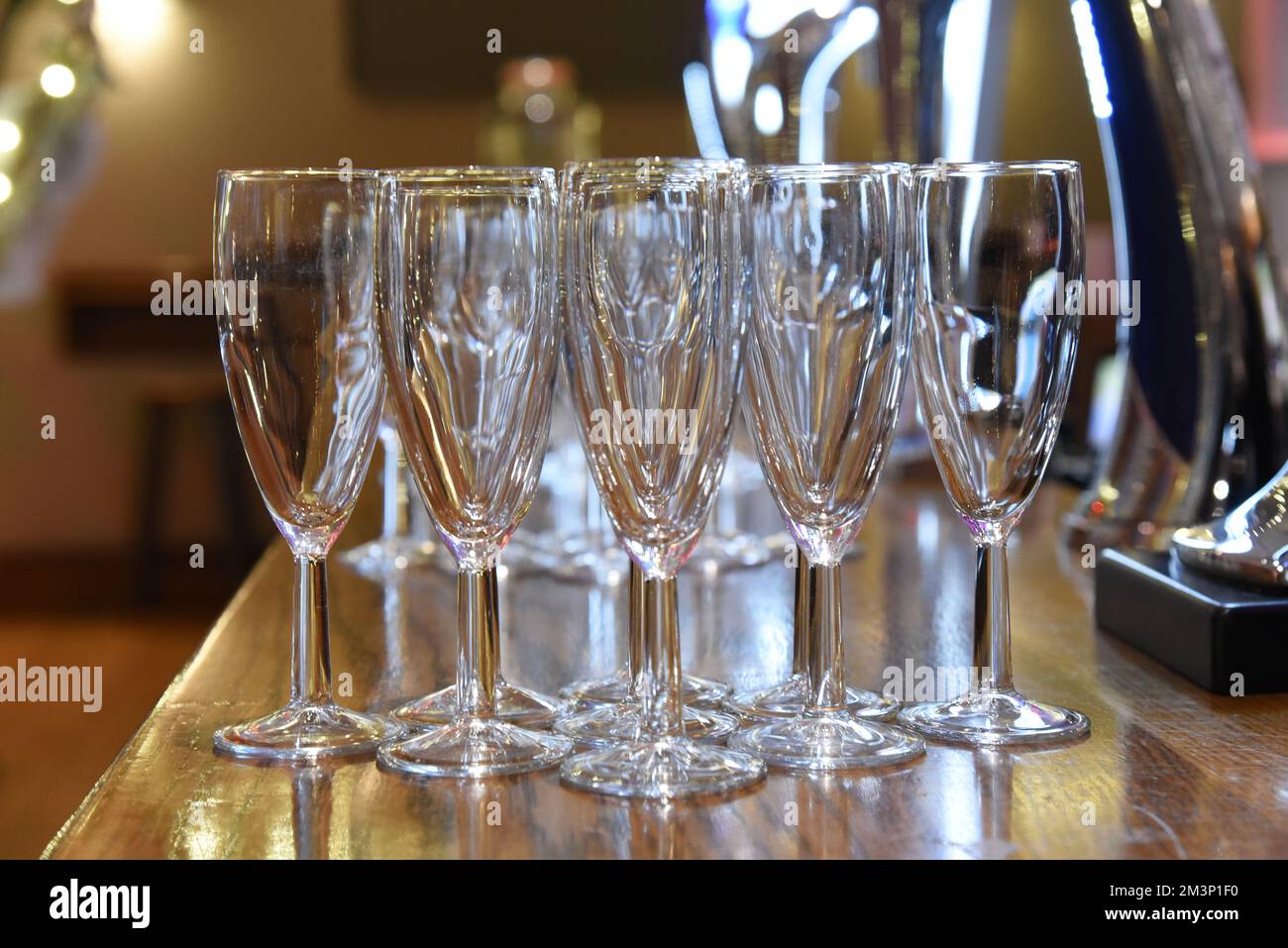 Empty champagne glasses on a bar Stock Photo