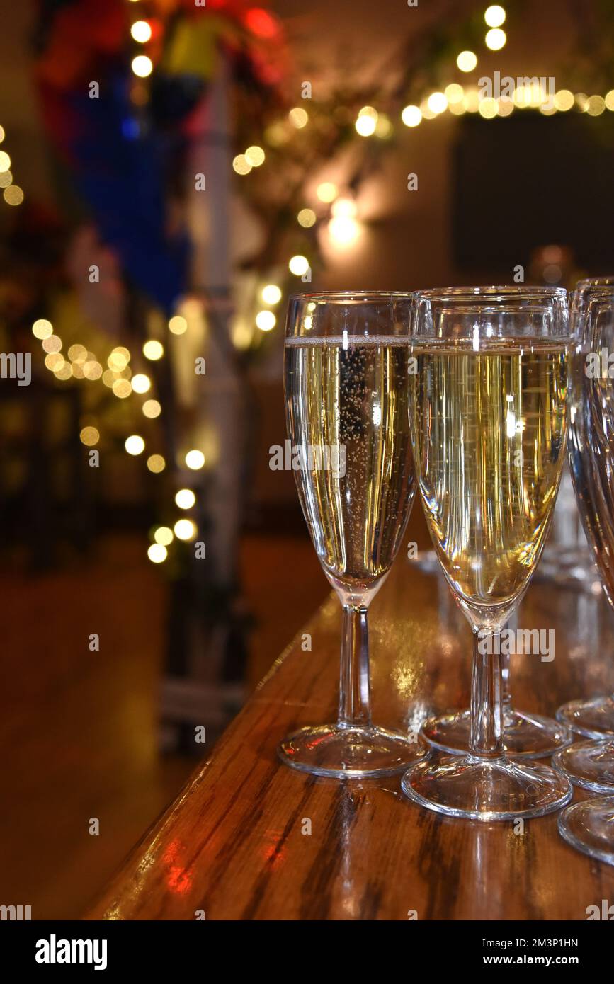 Celebratory drinks on a bar with soft focus fairy lights in the background Stock Photo