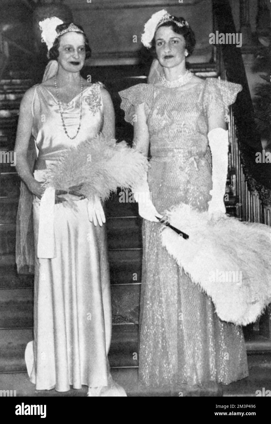 Lady Willoughby de Eresby and Mrs Ronald Tree (better known as Nancy Lancaster), billed in The Tatler as M.P.'s wives on their presentation at court at Buckingham Palace. Nancy Lancaster (1897 - 1994), nee Perkins, was an influential American-born tastemaker, interior decorator and garden designer. She married Ronald Tree in 1920, moving to Britain in 1927; the couple divorced in 1947 and she married Claude Lancaster in 1948. She was associated with the English Country House Style.     Date: 1934 Stock Photo