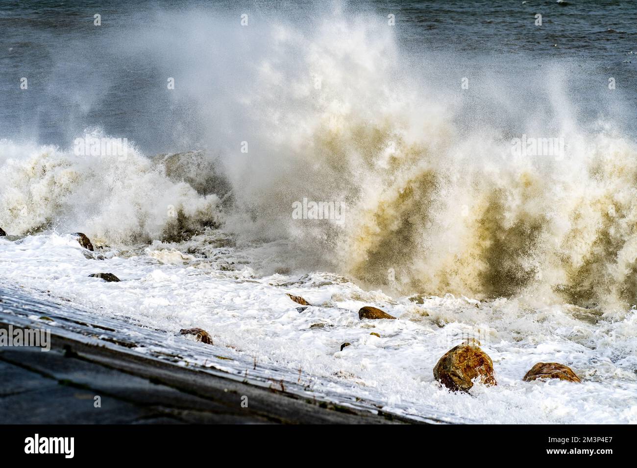 The stormy sea waves splashing against a rocky seashore Stock Photo - Alamy