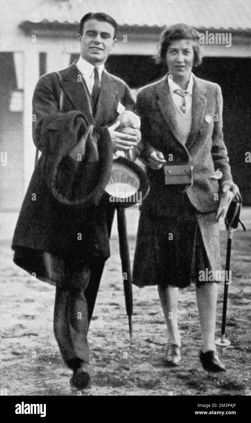Prince Aly or Ali Khan (1911 - 1960), son of Aga Khan III, socialite, playboy, racehorse owner, third husband of Rita Hayworth and swain of Margaret Whigham and Thelma, Viscountess Furness. Pictured with Miss Mala Brand on familiar 'turf' at Warwick races.     Date: 1930 Stock Photo