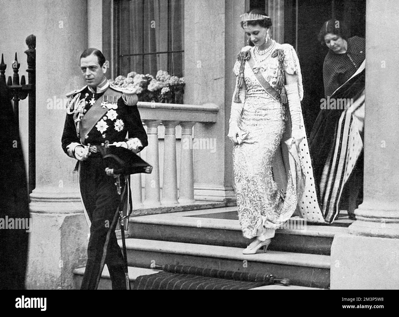 George, Duke of Kent (1902-1942) in naval uniform and his wife, Marina, Duchess of Kent leaving their home at 3 Belgrave Square for Buckingham Palace prior to the Coronation of the Duke's elder brother, King George VI on 12 May 1937.        Date: 1937 Stock Photo
