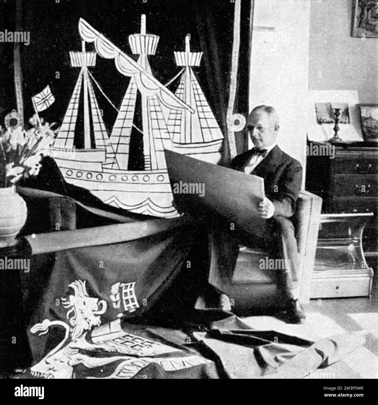 George Grey Wornum (1888-1957), British architect, pictured at his drawing board in the midst of designing street decorations around London for the Coronation of King George VI in 1937.     Date: 1937 Stock Photo