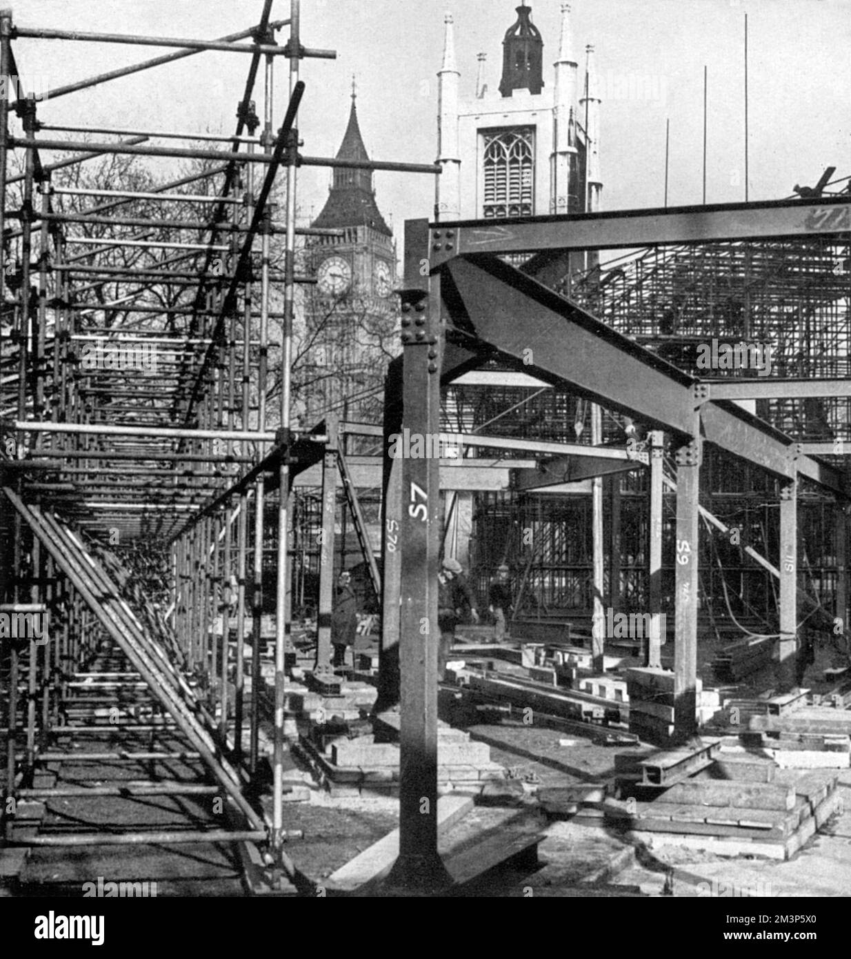 A mass of steelwork in the course of construction in Parliament Square to provide accommodation for those fortunate thousands who would witness the arrival and departure of King George VI and Queen Elizabeth at Westminster Abbey during the Coronation on 12 May 1937.  At each Coronation, a mass of temporary seating was erected along the processional route.     Date: 1937 Stock Photo