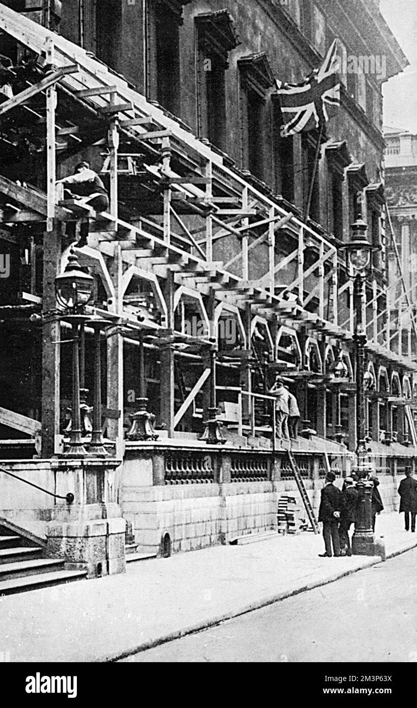 Special stands and viewing galleries being constructed on the front of the Reform Club in Pall Mall, London from where members and their families could watch the Coronation procession of King George V in June 1911.      Date: 1911 Stock Photo
