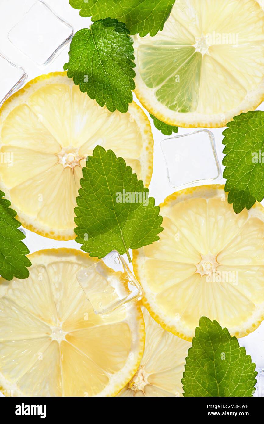 Texture with lemons, mint, ice cubes on white isolated background Stock Photo