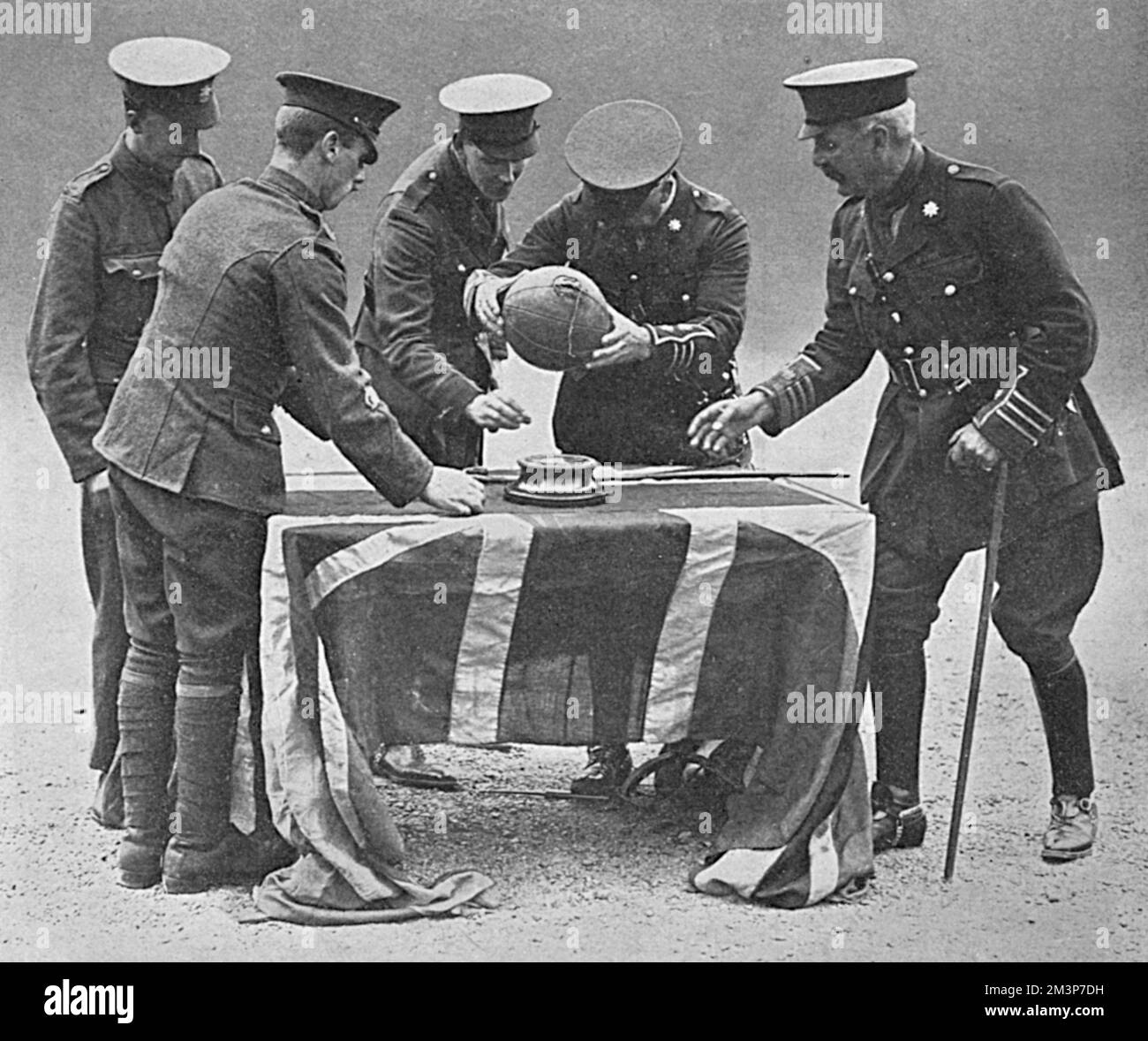 The actual football dribbled by Captain Neville (who was killed in action) towards the German trenches during the attack on Montauben by the East Surreys, fixed by Lt.-Col. H. P. Treeby, D.S.O. to its stands during a commemoration ceremony at Kingston barracks.  See picture no. 10572967 for the attack as depicted by R. Caton Woodville.      Date: 1916 Stock Photo