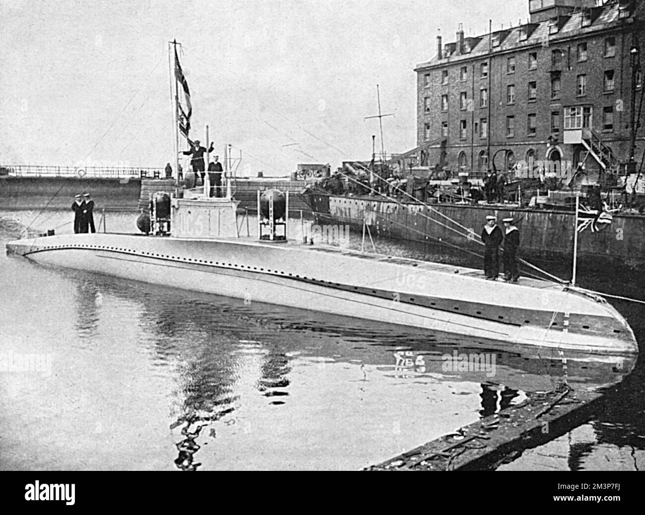 U C 5, a captured German submarine, exhibited at Temple Pier in London with the British ensign flying over the German flag.       Date: 1916 Stock Photo