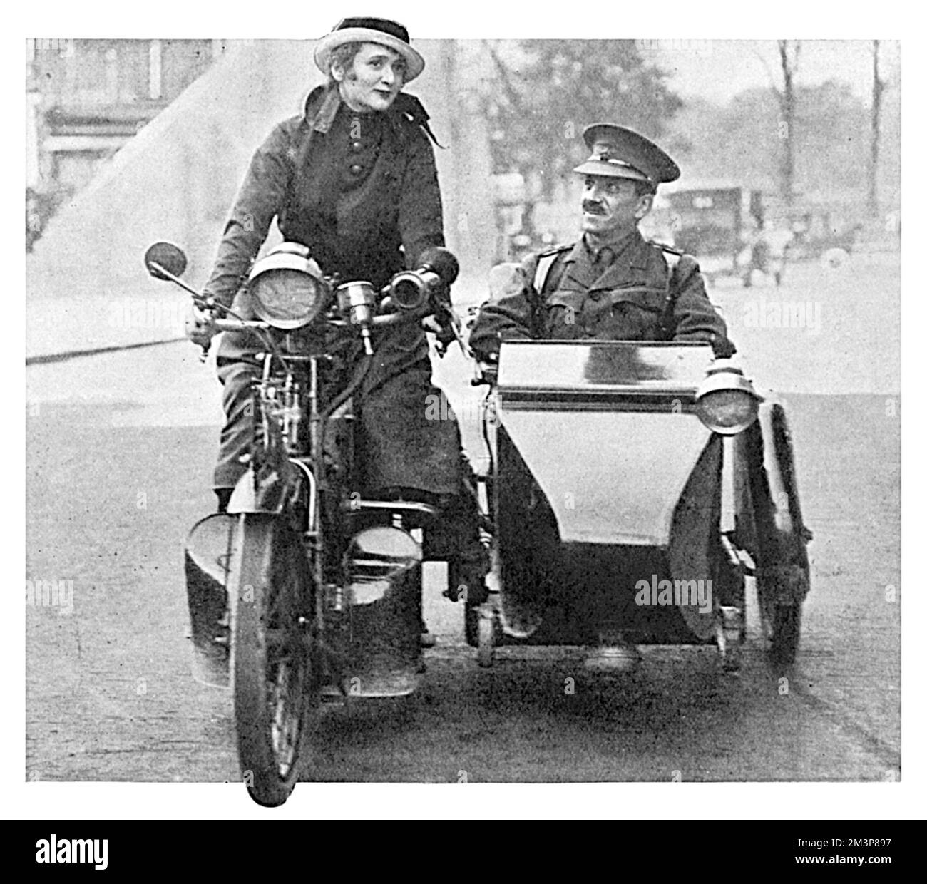 Gaby Deslys (1884 - 1920), French actress, music hall artiste and sometime lover of King Manuel II of Portugal, takes a wounded soldier for a ride in a motorcyle sidecar.  Gaby was one of the most popular entertainers of the First World War, and involved herself in a wide variety of charity work and morale-boosting activities in Britain.     Date: 1915 Stock Photo