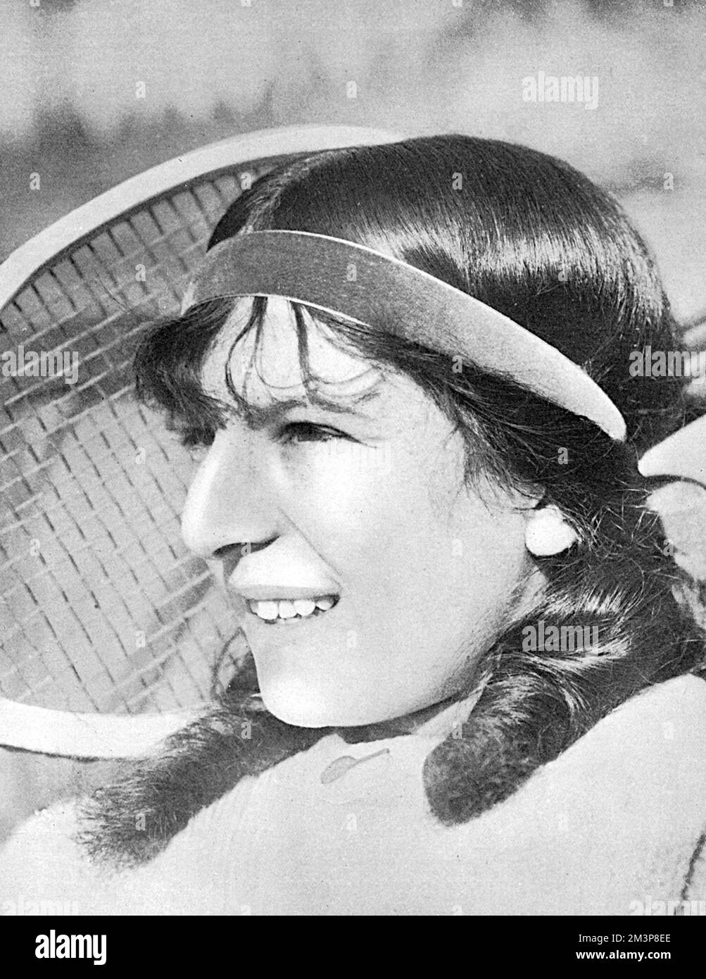 Suzanne Lenglen (1899 - 1938), French tennis player, winner of 81 singles titles during the 1920s.  Pictured as a precocious fifteen year old in The Tatler, which writes, 'Playing in the German style she seldom misses a shot, like Mr. Wilding (Anthony Wilding, NZ tennis player who won Wimbledon four times), from whom she learnt much of her game on the Riviera last season, and is at her best on the base-line...One day she may win the English championship.'     Date: 1914 Stock Photo