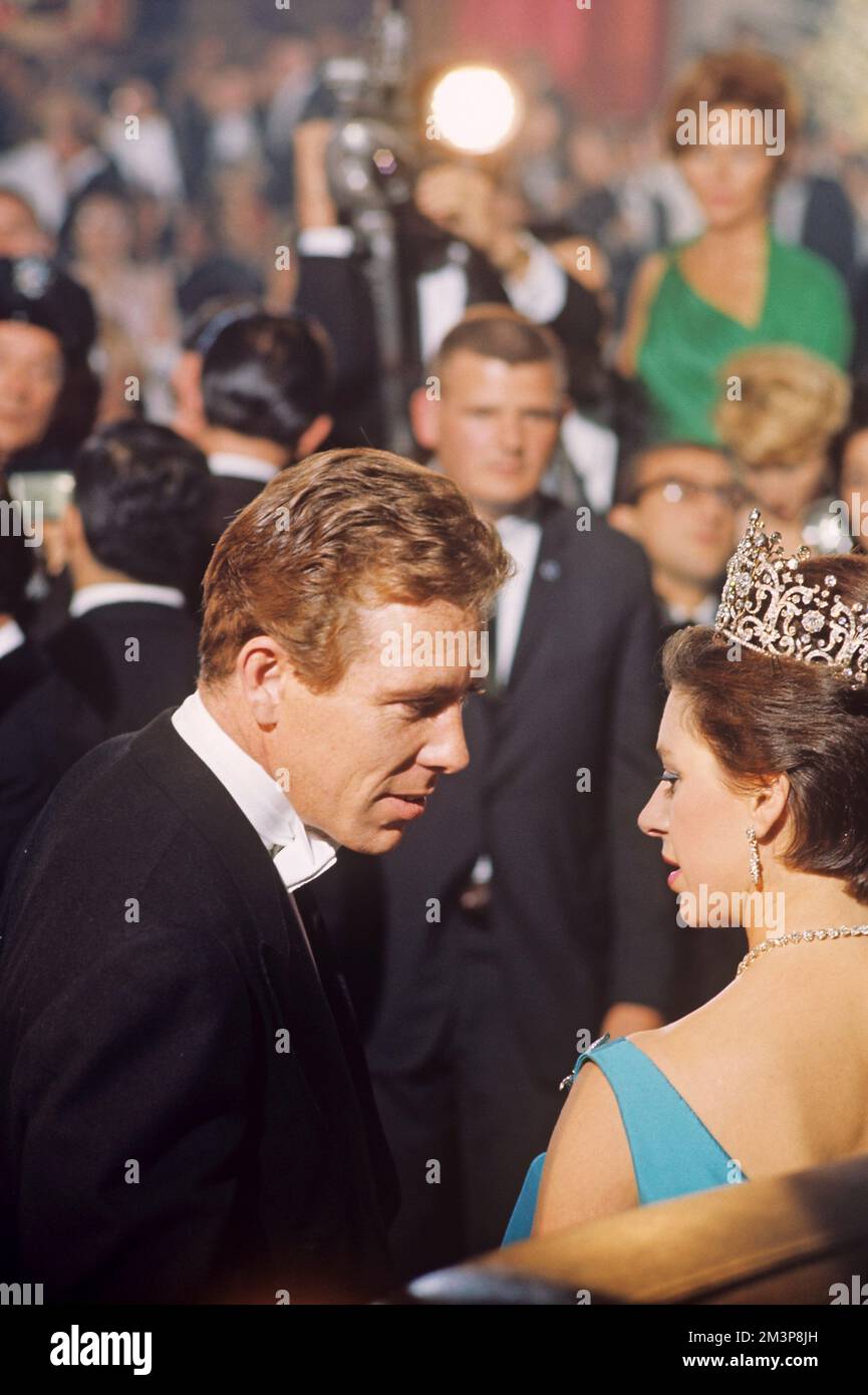 Anthony Armstrong Jones (1930-present), also known as Lord Snowdon, pictured speaking to his wife at the time Princess Margaret (1930-2002) at a formal event.     Date:  circa 1960s Stock Photo