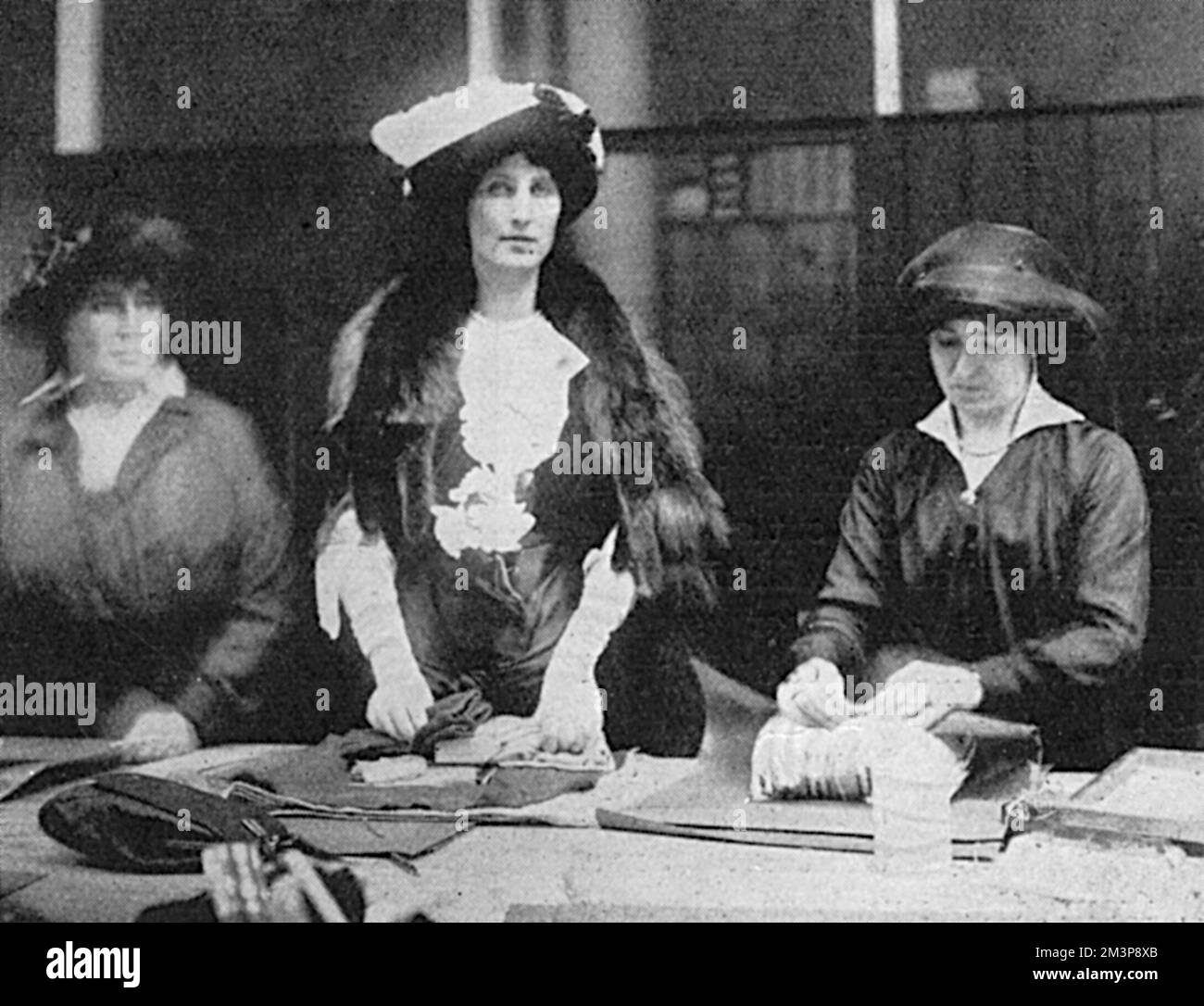 The Duchess of Portland pictured 'doing her bit' for the war effort by helping to pack parcels for Queen Alexandra's Field Force Fund, ready to be sent to the front.       Date: 1915 Stock Photo