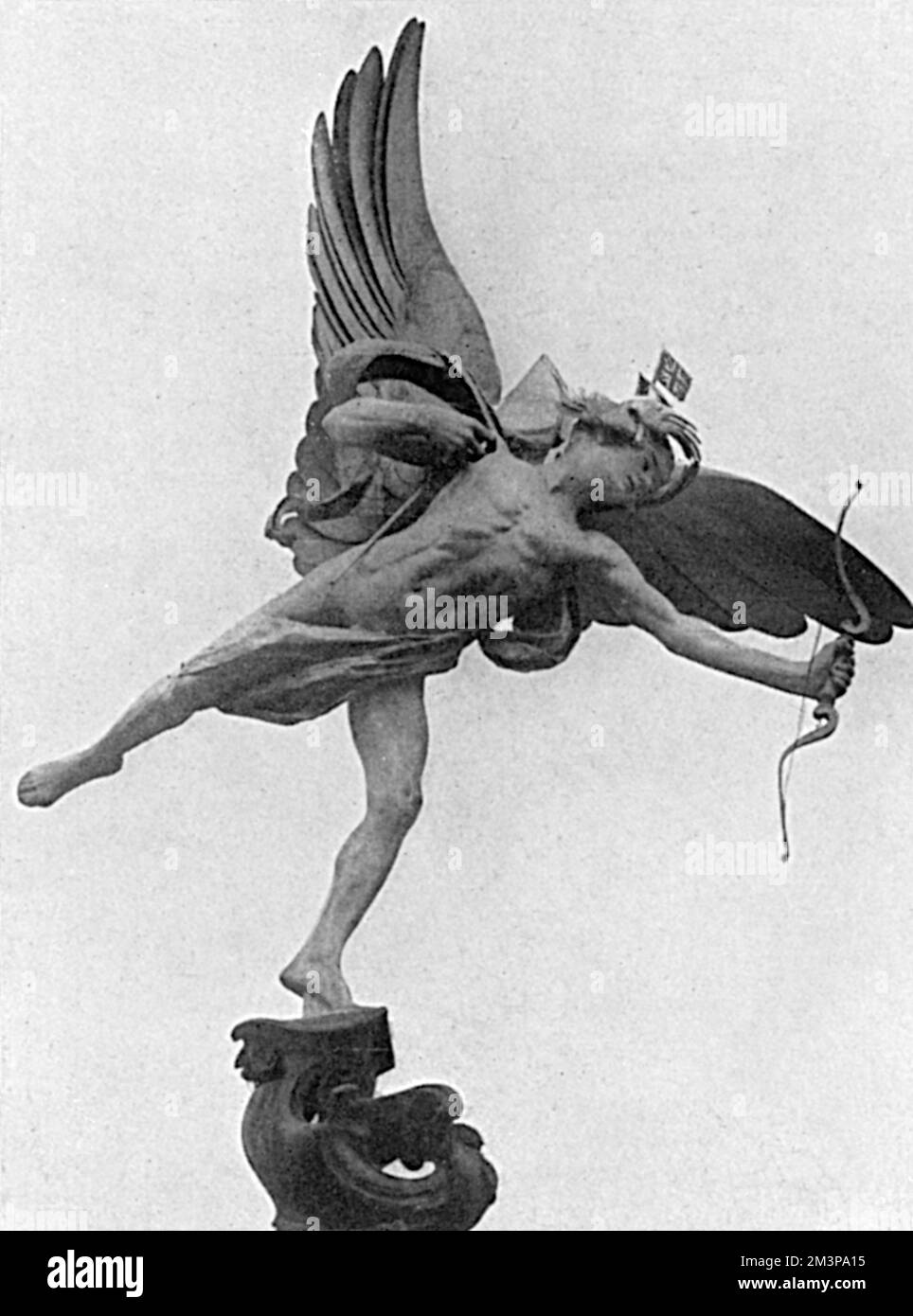 The head of the Piccadilly Circus statue, Eros, decorated with the Union Jack and Tricouleur flags in the early weeks of the First World War.       Date: 1914 Stock Photo