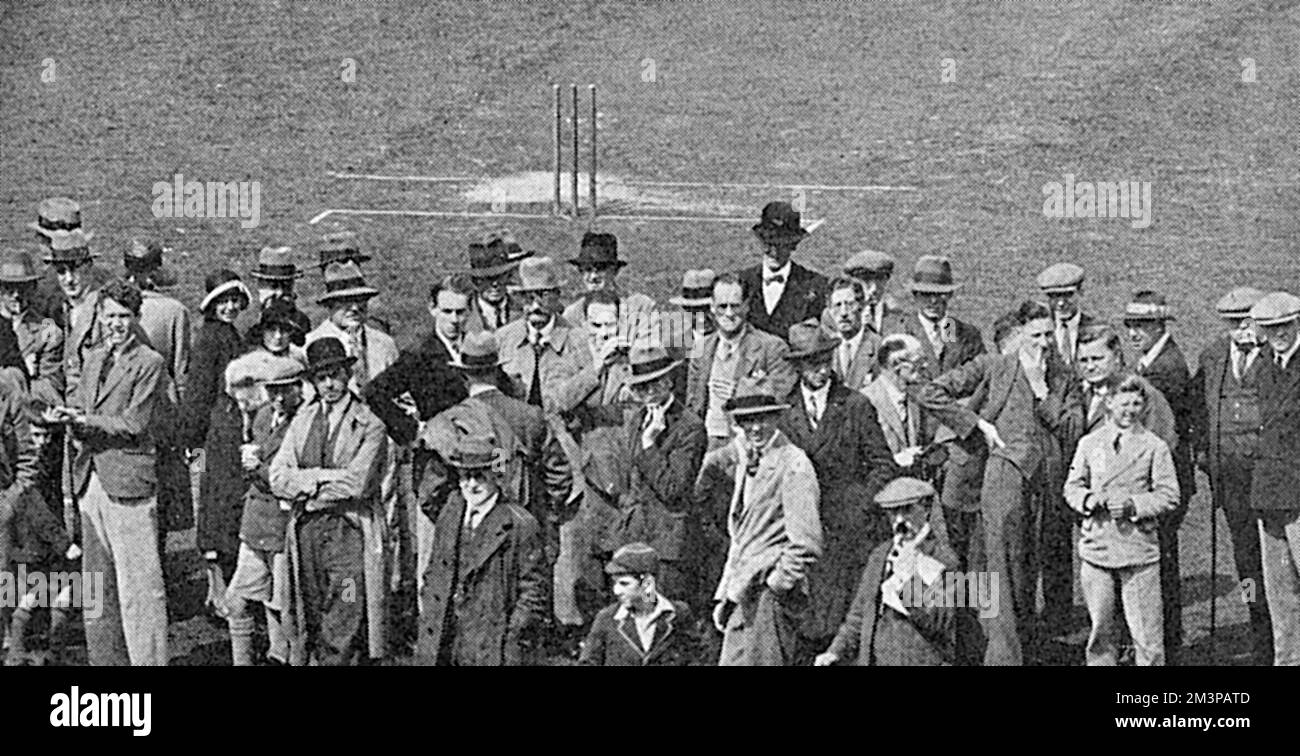 Impatient cricket spectators gather near the square at the Oval during an interruption in play in the match between Surrey and Yorkshire. The illustrated Sporting and Dramatic News described the crowd as 'unruly' and reported an unsavoury incident...&quot;When the umpires walked out...to inspect the pitch, during the Yorkshire and Surrey match, which was interrupted by rain, one of the more impatient members of the crowd kicked (Frank) Chester and struck at (Denis) Hendren. This cowardly on the two most innocent people involved in the matter is rendered more discreditable to the Oval crowd sin Stock Photo