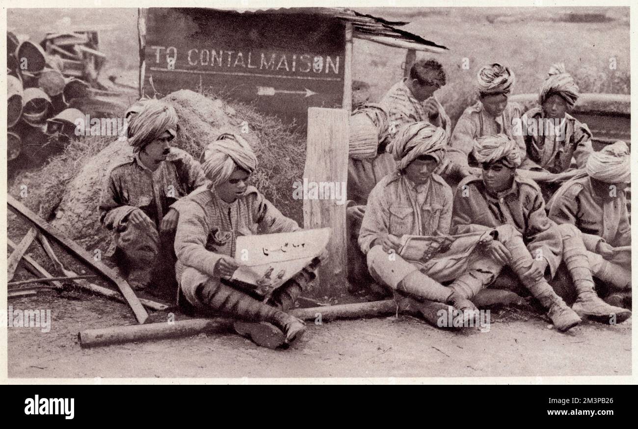Indian soldiers sitting and reading newspapers near to Contalmaison, France, during the First World War.     Date: 1917 Stock Photo