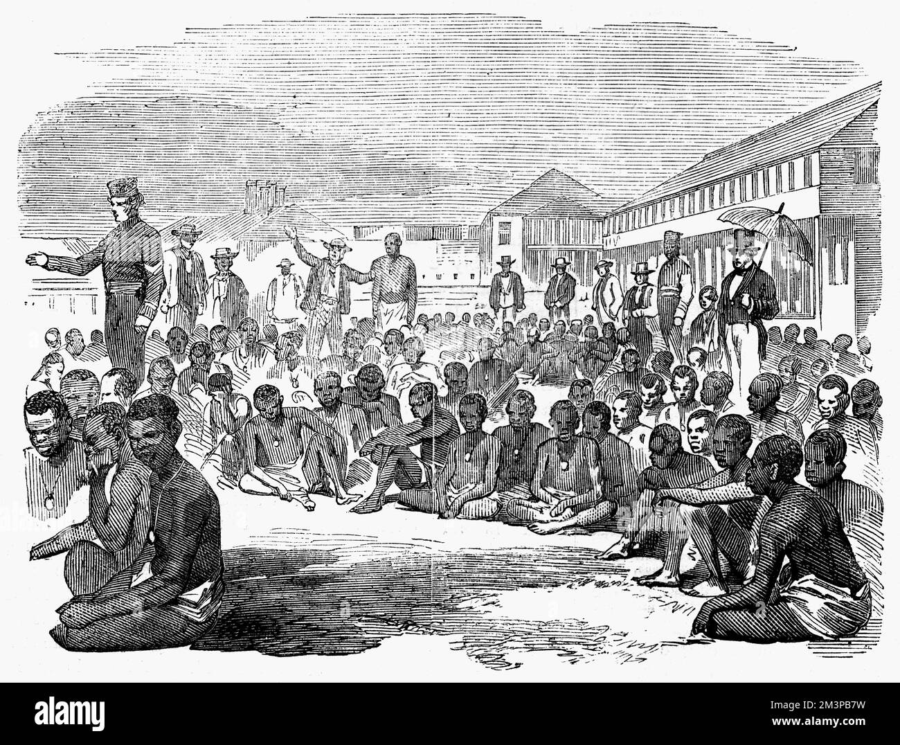 Group of slaves on the parade at Fort Augusta, Jamaica. The slaves were captured from a slave trading schooner, and upon their arrival in the harbour of Kingston, Jamaica, were landed at Fort Augusta. Several were so exhausted from their terrible journey that they since died.     Date: 1857 Stock Photo