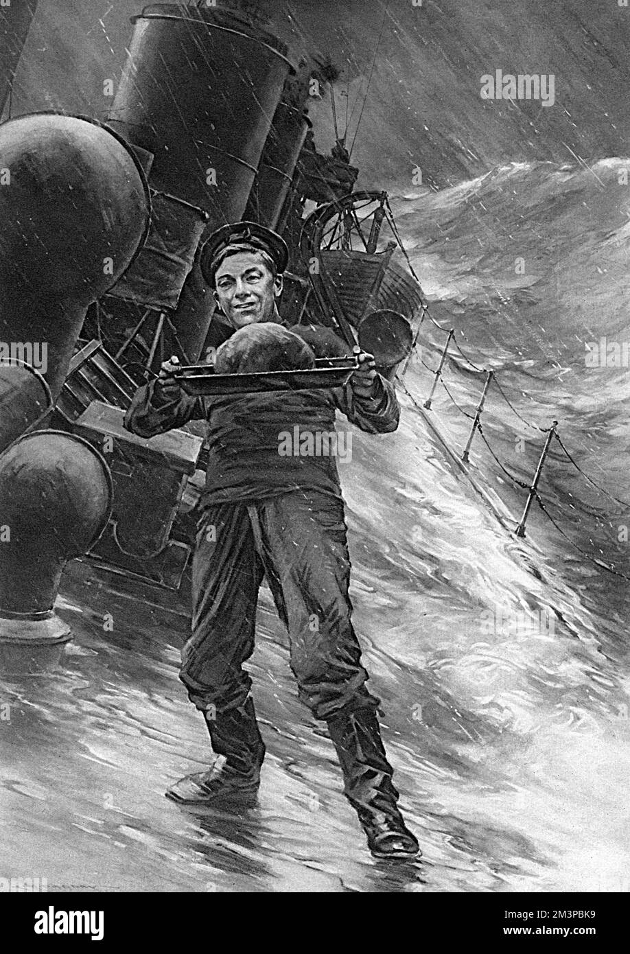 A sailor on board a Royal Navy battleship keeps his balance on deck during a storm in order to preserve a fine Christmas pudding which has been sent from home.       Date: 1916 Stock Photo