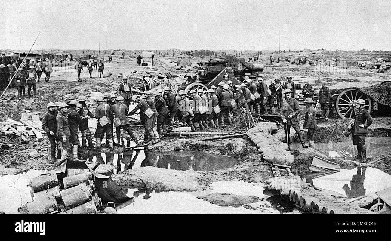 British soldiers moving a big gun forward across a waterlogged battle