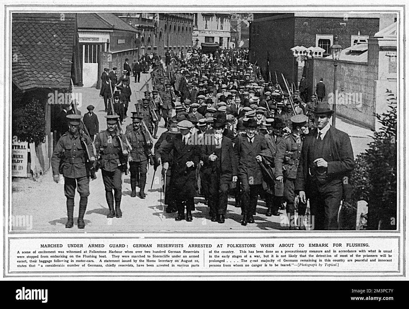 German reservists marching under armed guard after being arrested at Folkestone when they were about to embark for Flushing.  They were marched to Shorncliffe under armed escort and their baggage followed in motor cars.    1914 Stock Photo
