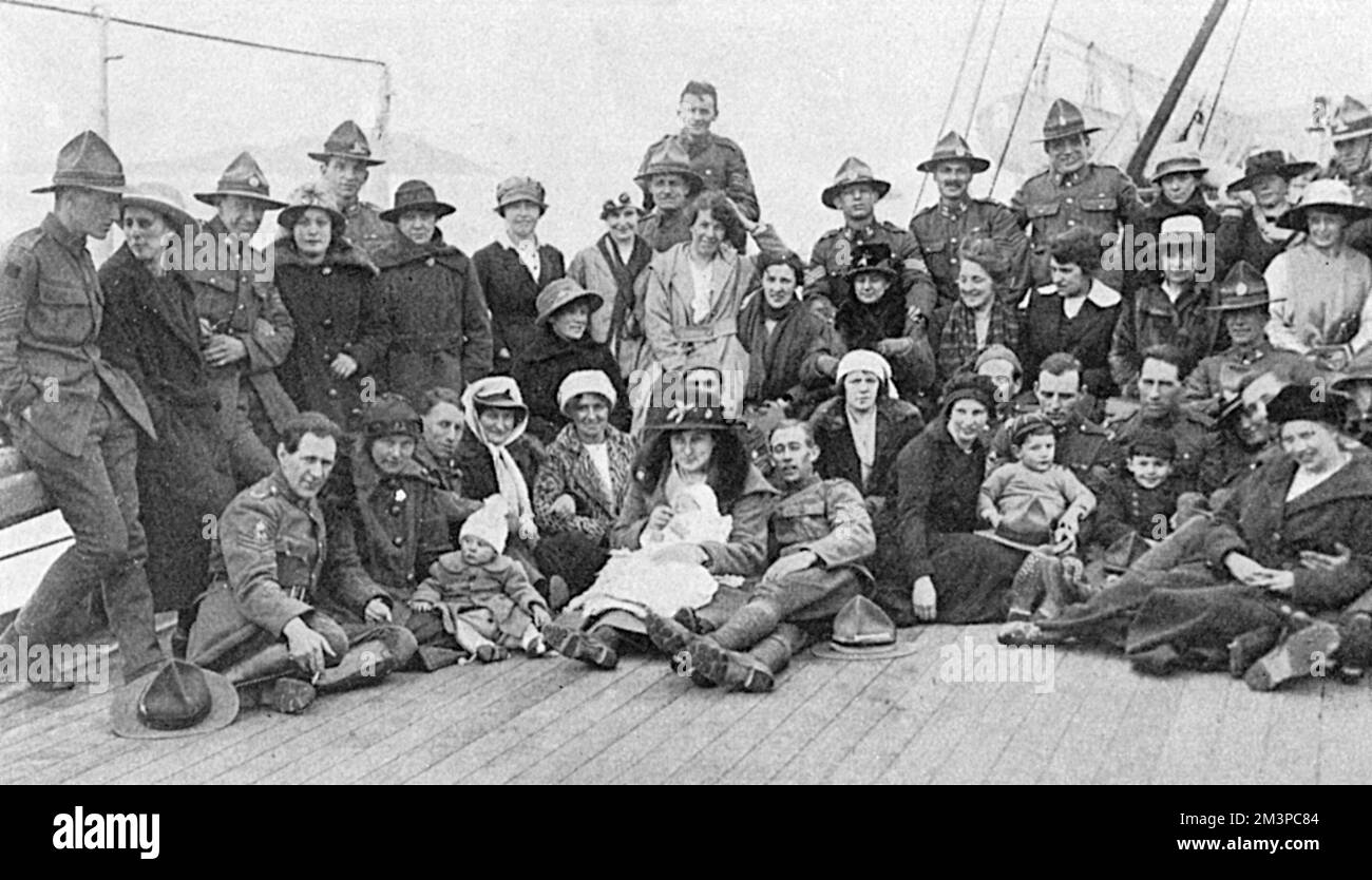 A party of New Zealand soldiers on board the Remuera, heading home accompanied by their English wives who they had met and married while in Britain.  In some cases, the couples are accompanied by children and babies.       Date: 1919 Stock Photo