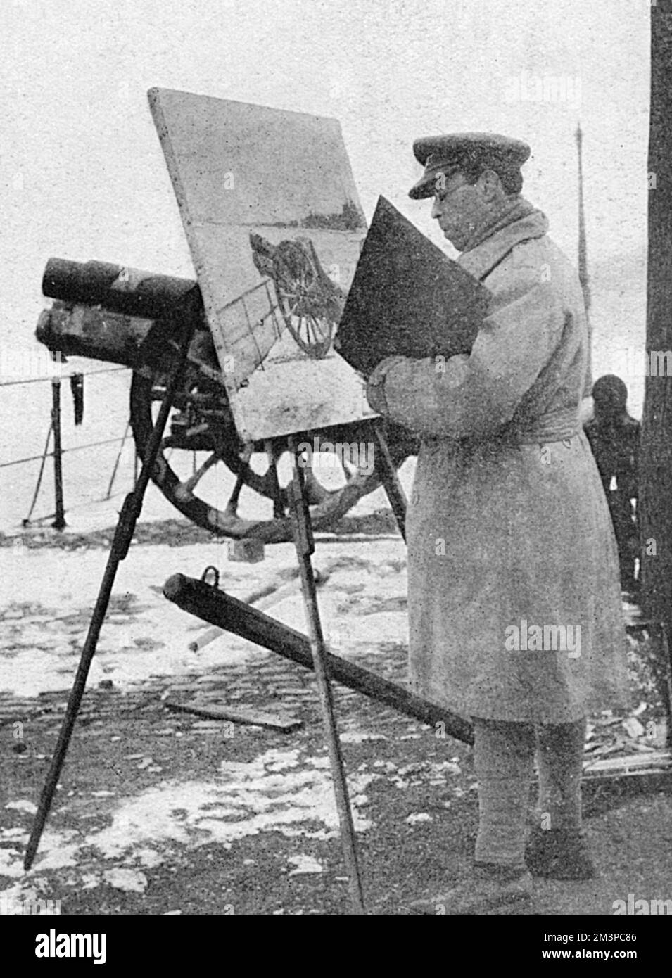 Sir William Rothenstein, one of the official artists of the Canadian War Records travelled with the Canadians to record their time occupying the Rhineland after the end of the First World War.  Pictured here at his easel painting a war scene.       Date: 1919 Stock Photo