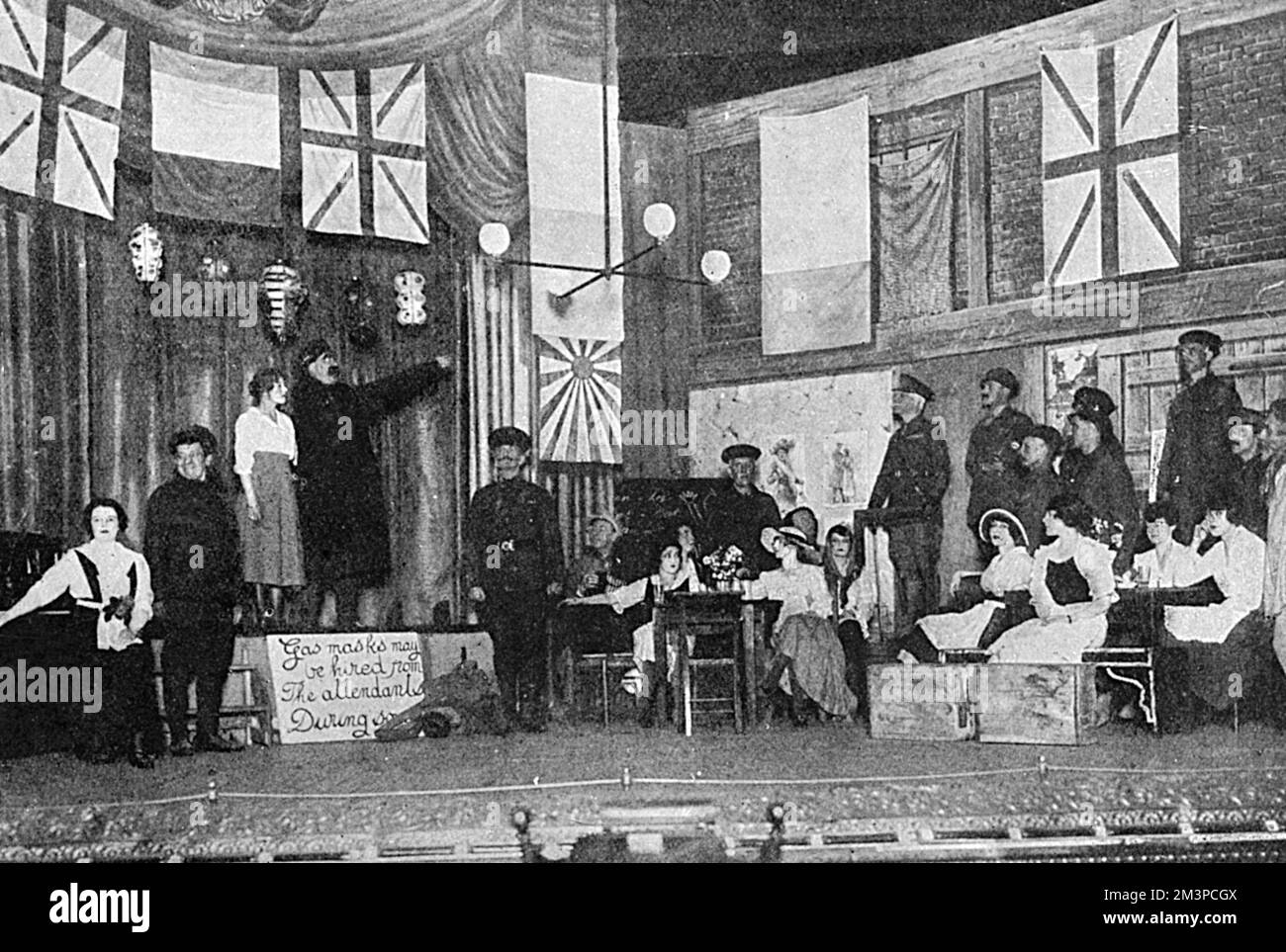 A scene from the play 'The Better 'Ole', co-written by Bruce Bairnsfather and featuring his popular character, Old Bill, which opened at the Oxford Music Hall on 4 August 1917 and ran for over 800 performances. Here, Old Bill is singing 'If you were the only girl in the world' and is interrupted by the entrance of his colonel     Date: August 1917 Stock Photo