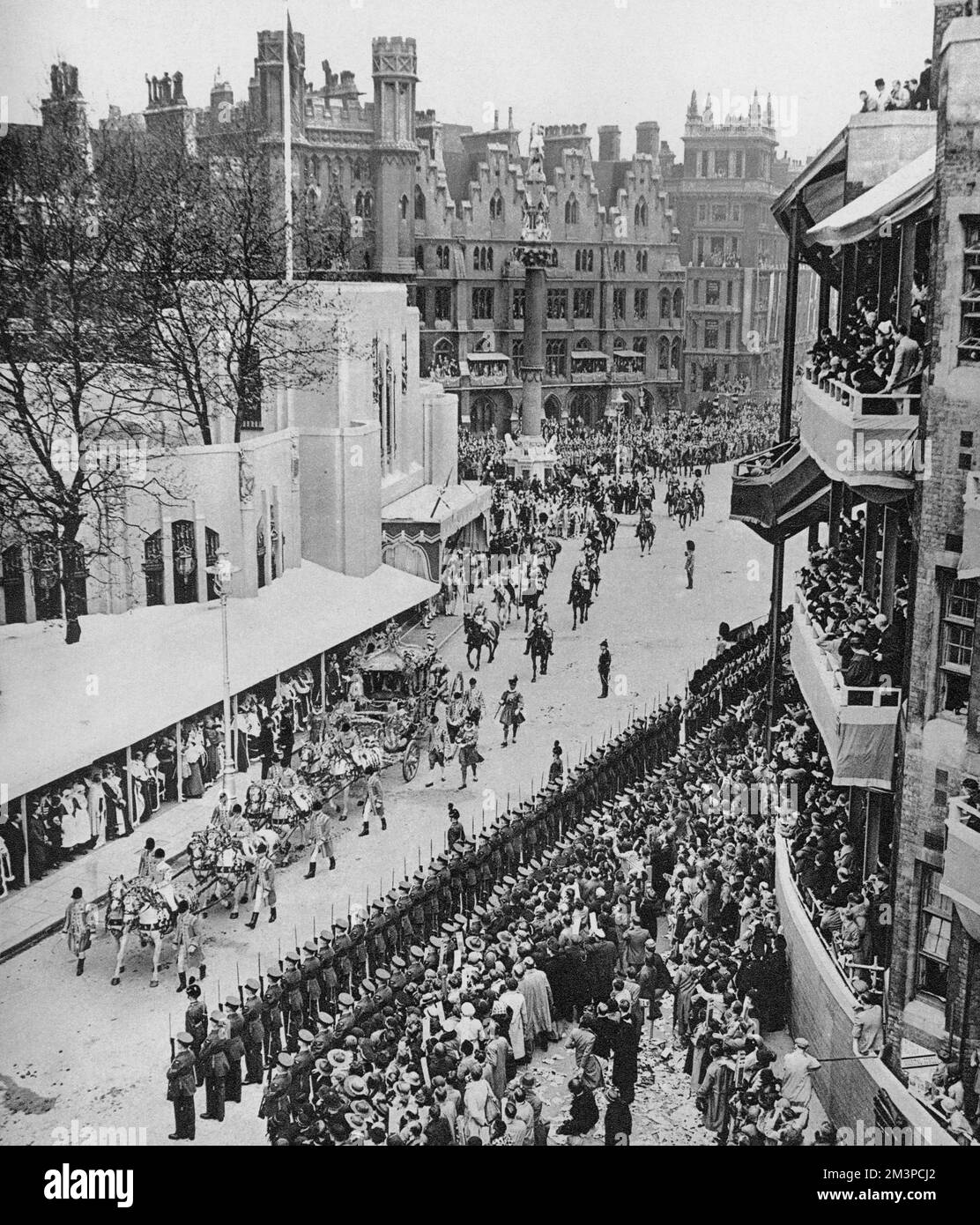 The Gold State Coach leaving the coronation of His Majesty King George VI (1895-1952), 1937. As seen here an annexe in the Art Deco style was constructed as an add-on to Westminster Abbey for the occasion. George VI's coronation took place on 12th May 1937 at Westminster Abbey, the date previously intended for his brother Edward VIII's coronation. Stock Photo