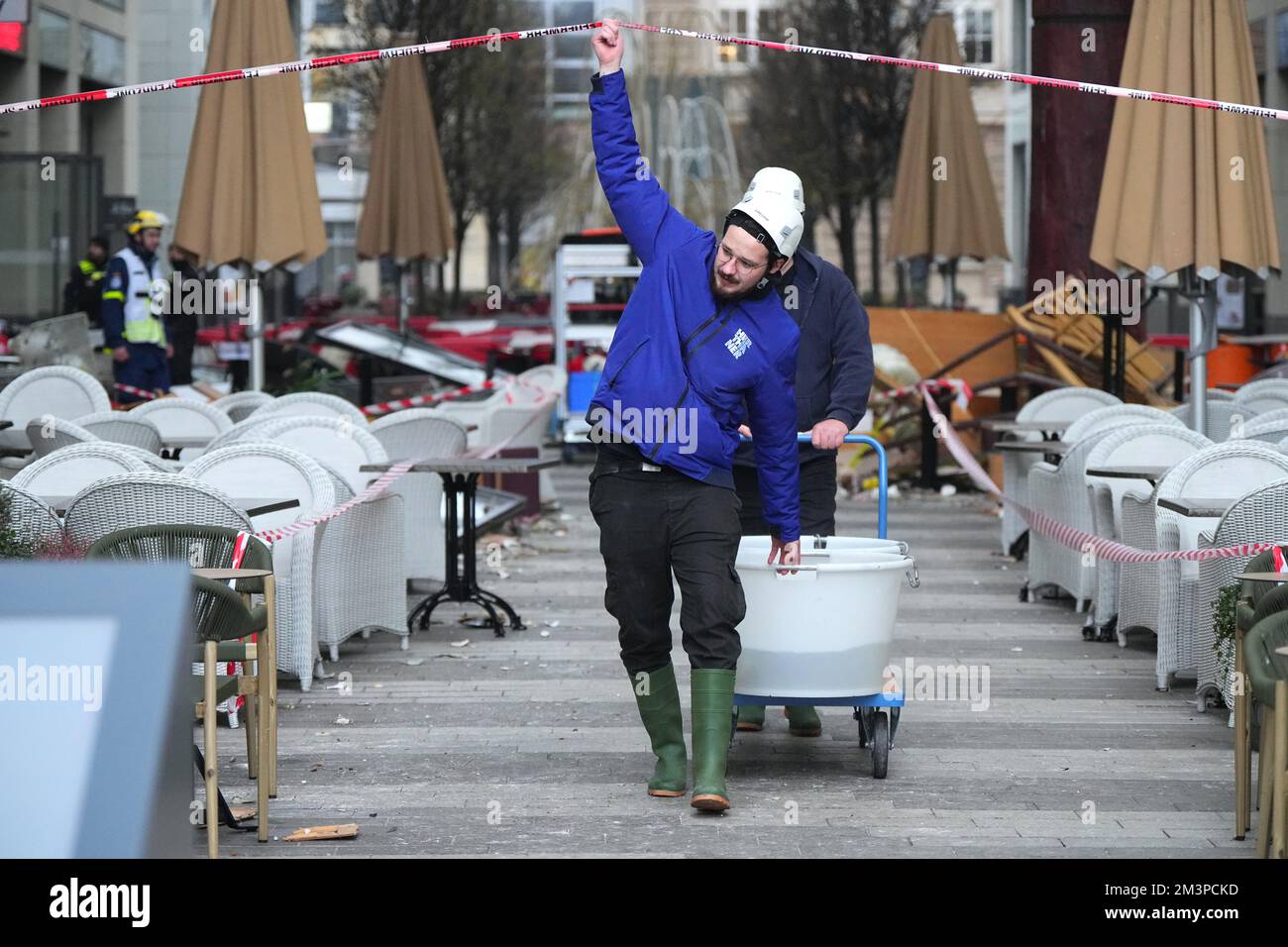 Berlin, Germany. 16th Dec, 2022. Two helpers bring fish in water tanks