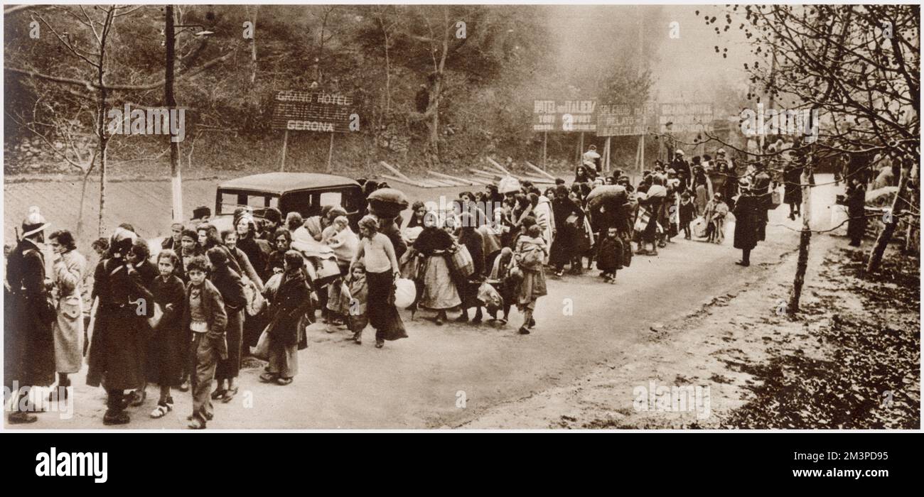 Some of the Republican refugees who fled Spain for France after the fall of Barcelona. Straggling line of women and children marshalled by French Gardes mobiles, while crossing the frontier. Stock Photo
