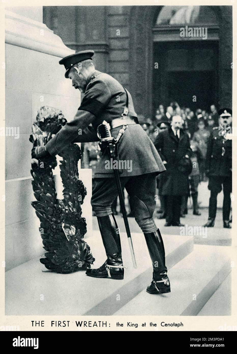 On 11th November 1919, the first anniversary of Armistice day, the Britsh nation, in reponse to an invitation by King George V, stood in silence for two minutes at 11 o'clock in remembrance of all who had given their lives in the First World War. Here is a photograph of King George V, laying a wreath at cenotaph a monument erected in honour of people whose remains are elsewhere, located in Whitehall, London.   11 November 1919 Stock Photo