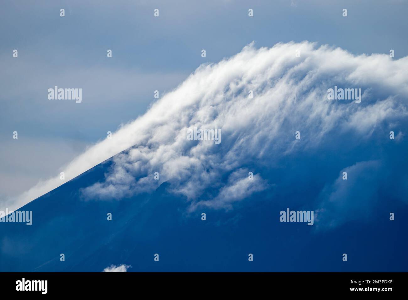 Clouds forming above volcano in the south Pacific Ocean - Ring of fire Volcano in Papua Stock Photo