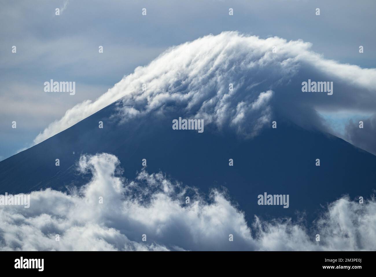 Clouds forming above volcano in the south Pacific Ocean - Ring of fire Volcano in Papua Stock Photo