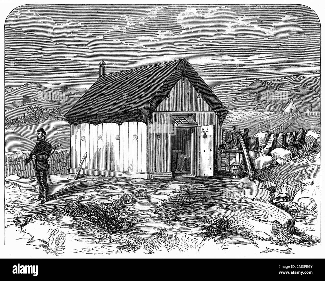 Portable hut for police in County Mayo, Ireland. A Royal Irish Constabulary policeman stands outside a portable hut used for temporary lodging when the armed constabulary are sent into a district where there has been unrest. This one is in Newfield, near Newport in the county of Mayo, overlooking Clew Bay.  1870 Stock Photo