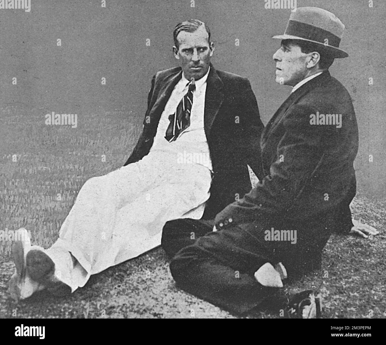 Anthony Wilding and Norman Brookes as &quot;gentlemen in waiting&quot; on the weather at the 1914 Wimbledon tennis championship in July 1914.  Wilding, who had won the last four consecutive men's singles championship was beaten in the final that year by Brookes.  He was killed the following May at the Battle of Aubers Ridge.       Date: 1914 Stock Photo