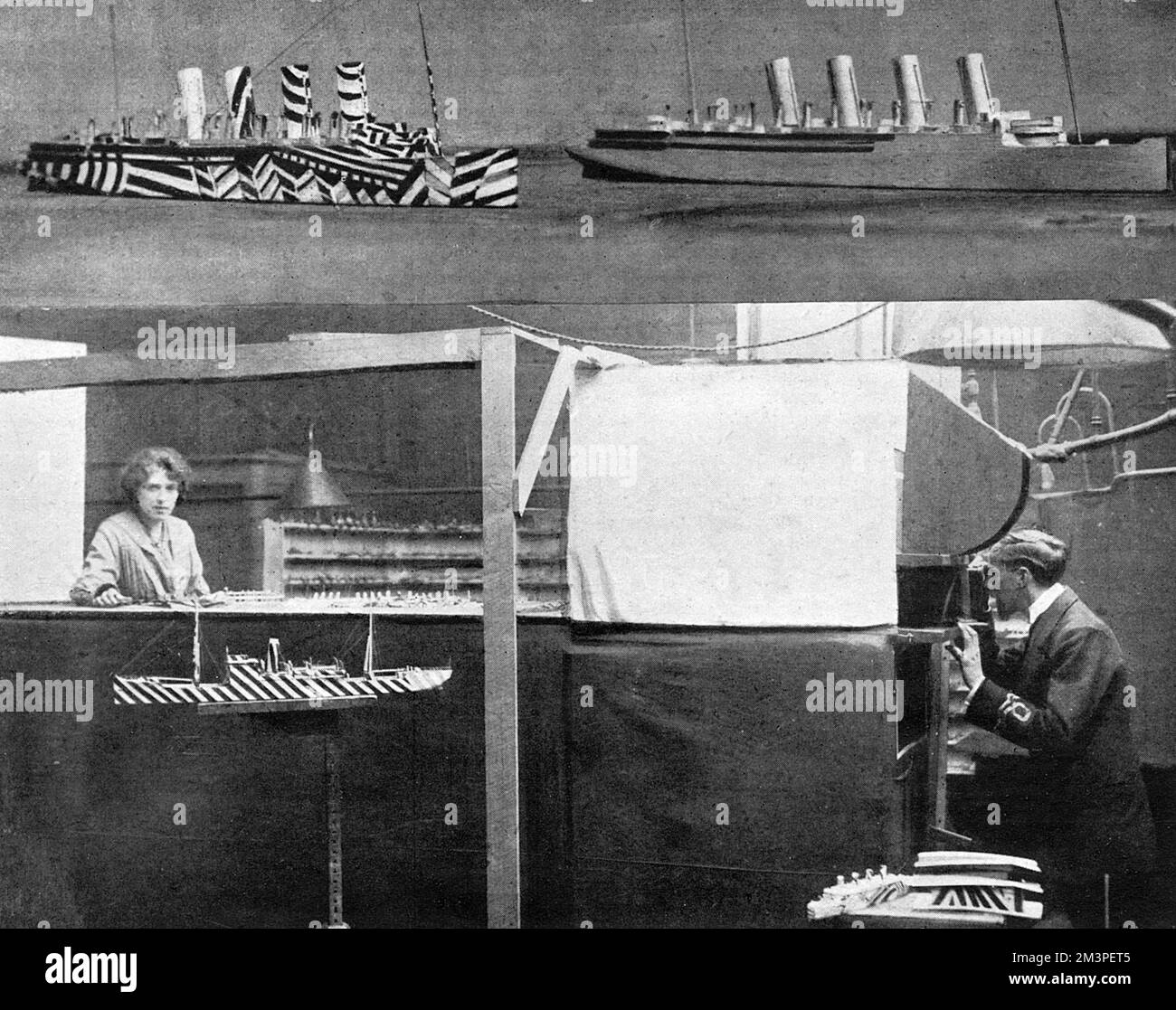 Photograph showing the experimental theatre on which dazzle designs, to camouflage ships were tested,  The officer on the right is observing a model through a periscope.  The two photographs above show the same ship painted in dazzle and one not.  The concept behind dazzle was to confuse submarines who were unable to calculate a ship's distance because of the breaking up accepted lines and general form.  It also meant that longer observation was required through a periscope  which meant the position of the submarine might also be detected by a lookout and attack avoided by alteration of course Stock Photo