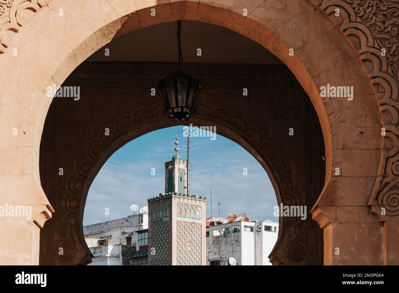 Mosque minaret see through out an ancient medina gate in Casablanca, Morocco Stock Photo