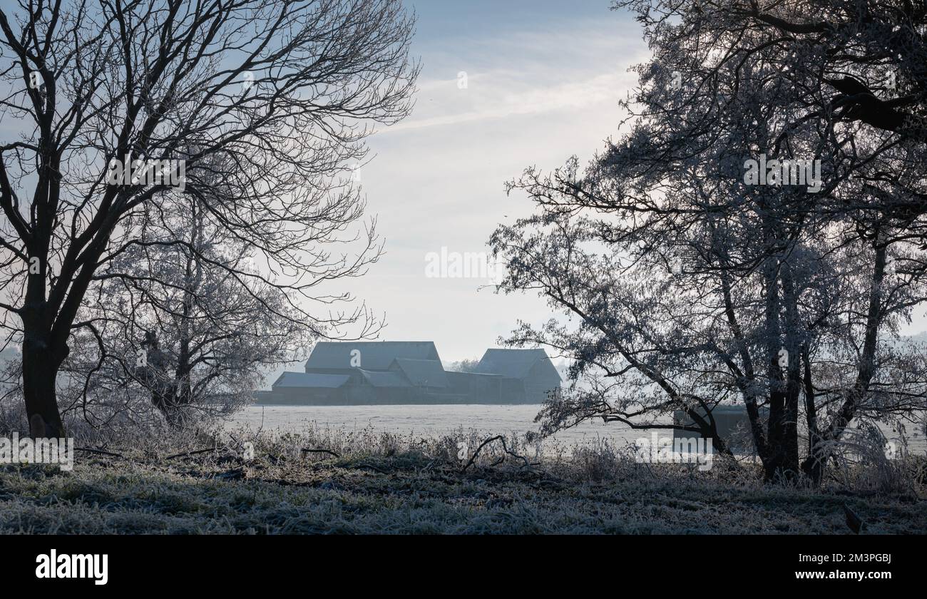 House and farm buildings in West Bergholt in Winter, December. Hoar frost on buildings and trees. Feathery frost. Stock Photo