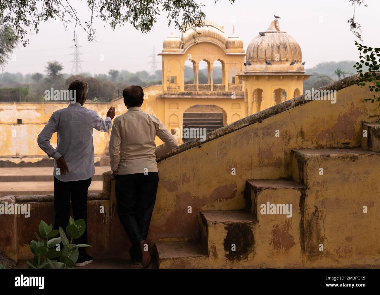 Indian men in front of a stepwell, Rajasthan, Ramgarh Shekhawati, India Stock Photo