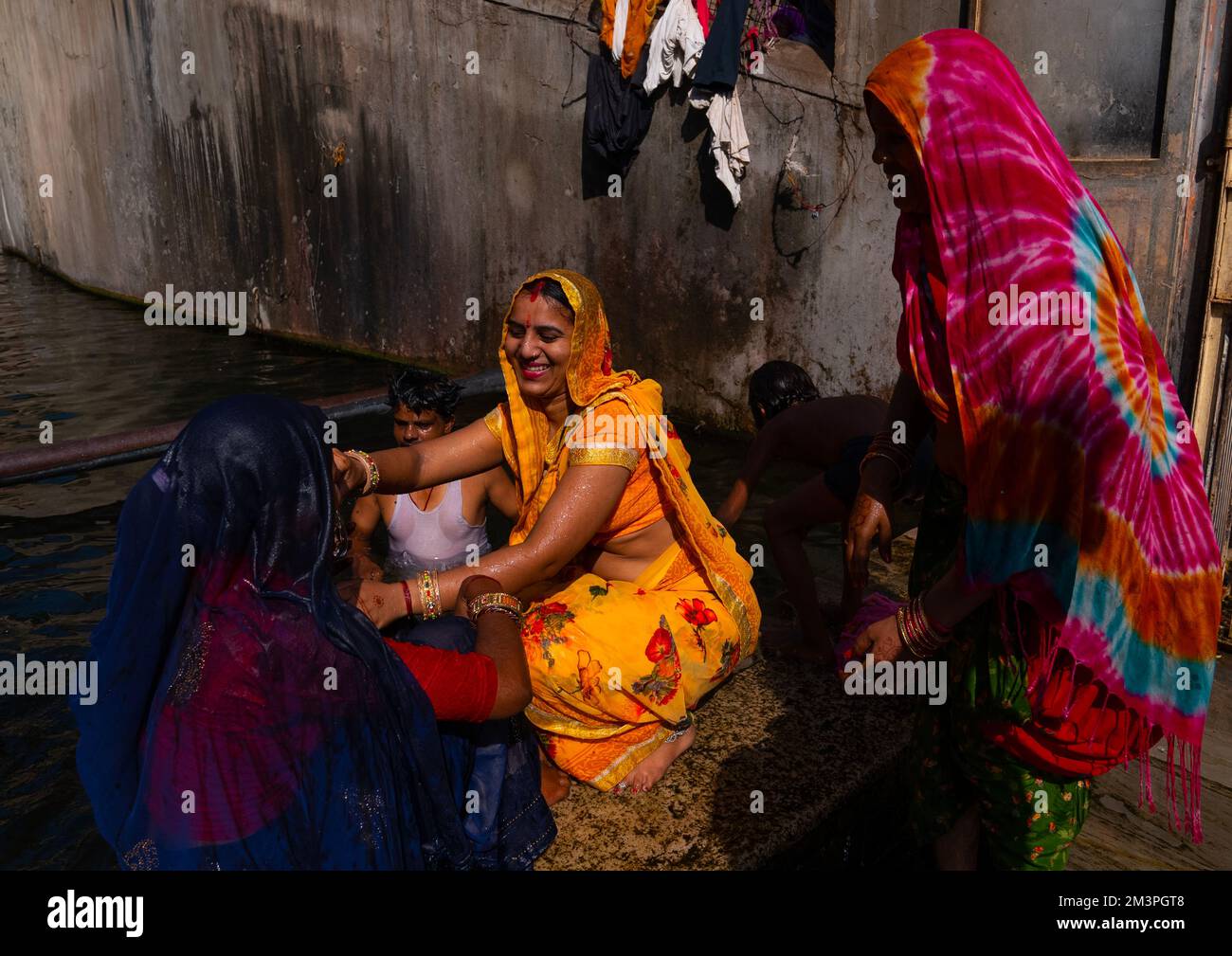 Indian pilgrims having a bath in Galtaji temple aka monkey temple, Rajasthan, Jaipur, India Stock Photo